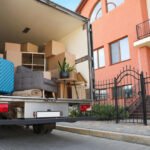 Truck of moving service outside a suburban home