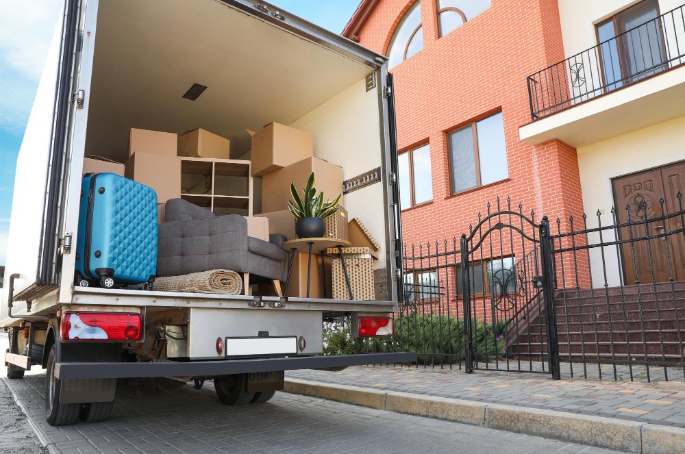 Truck of moving service outside a suburban home